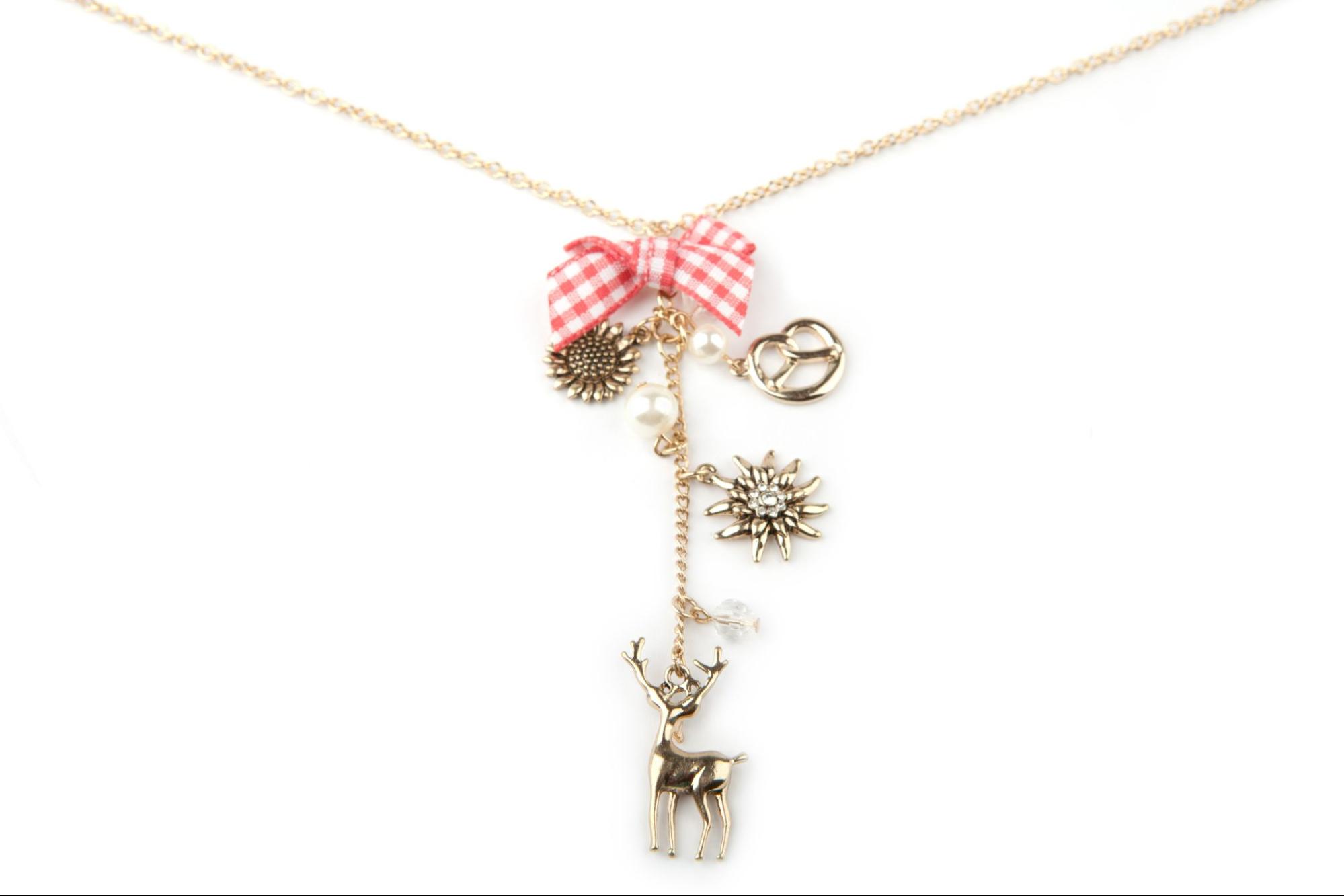 A yellow gold charm necklace with sunflower, pretzel, sun and reindeer charms