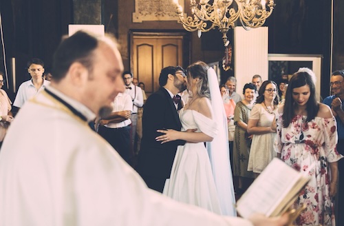 Couple kissing at their wedding at historic venue
